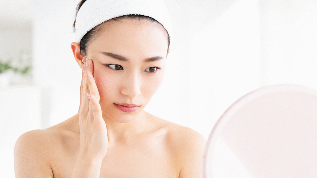 woman touching dry tight skin after washing face in minimal skincare routine