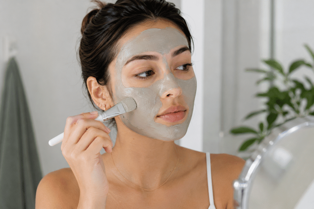 Photo of a girl applying clay mask