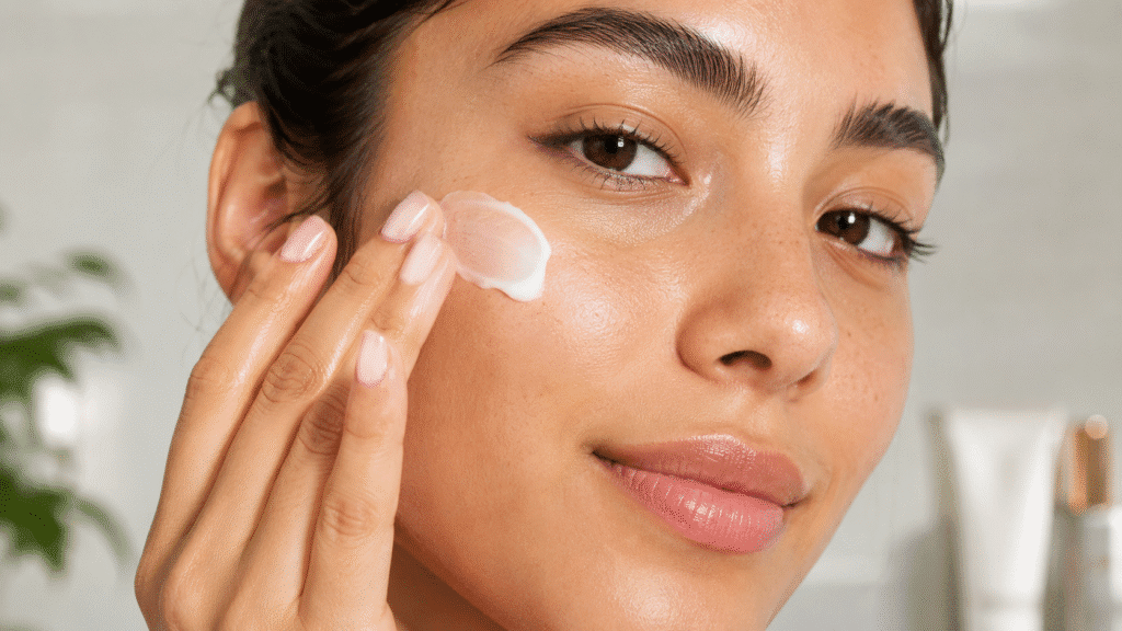 How Often Should You Moisturize Your Face? 1 Close-up of a woman applying facial moisturizer