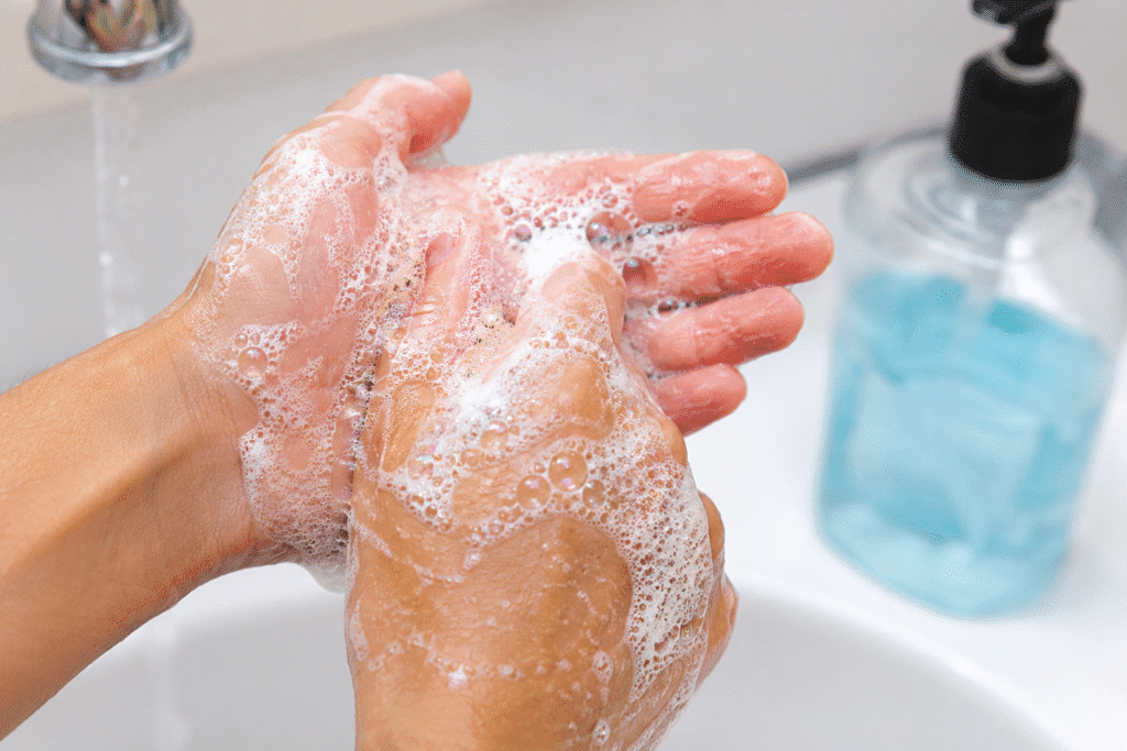 Close-up of hands being washed with foaming hand soap