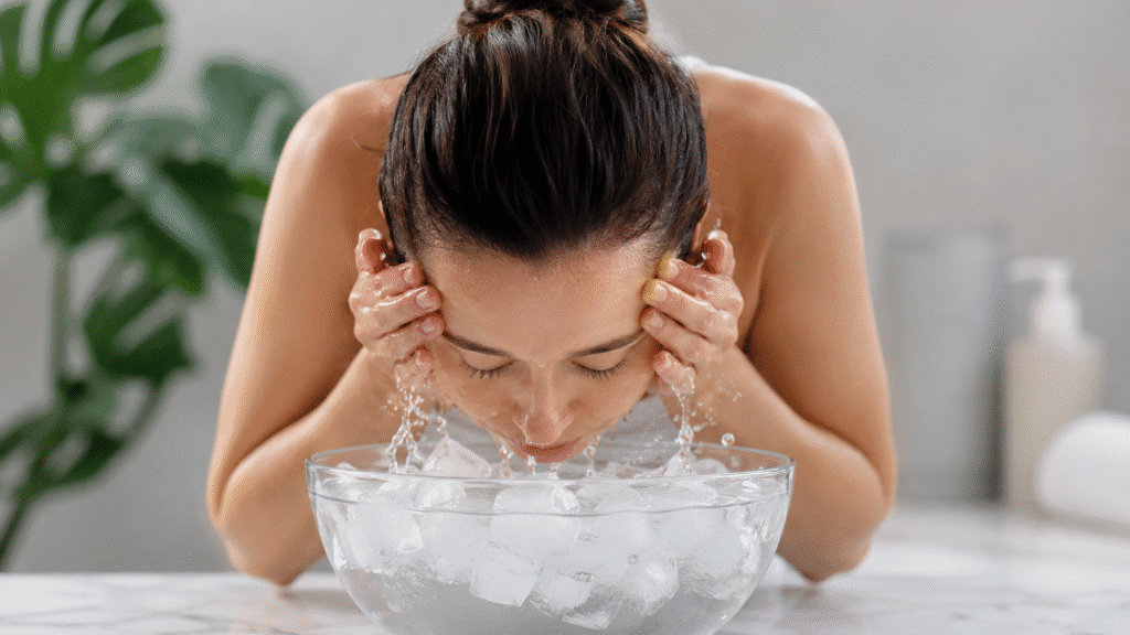 Woman dipping her face into an ice water bath.